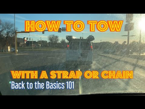 How to tow a vehicle with a strap or chain.
