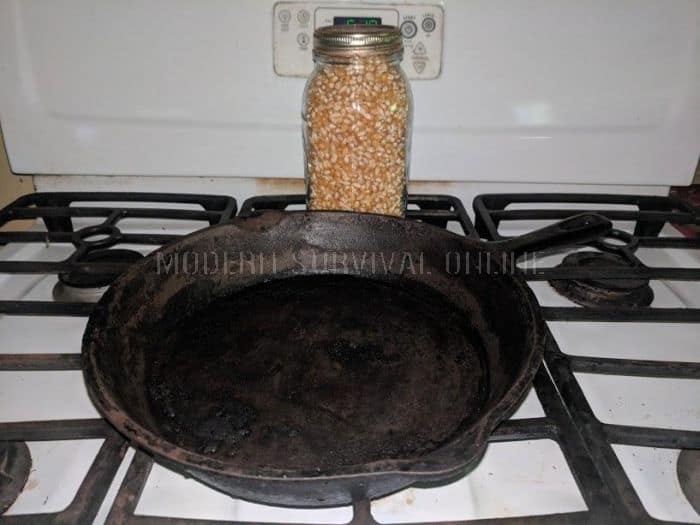 corn kernels in mason jar next to a cast iron skillet