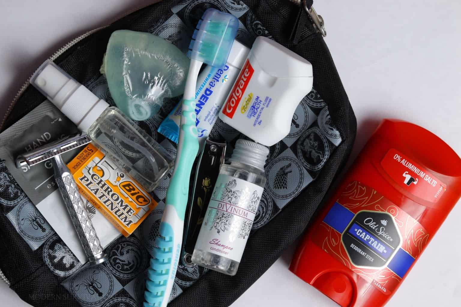 hygiene kit with toothbrush floss deodorant razor shampoo inside a pouch
