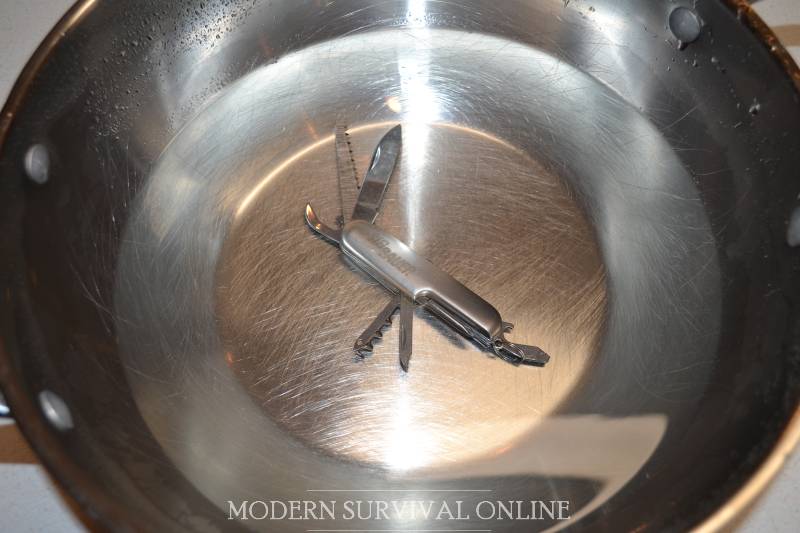 rinsing swiss army knife in water in bowl