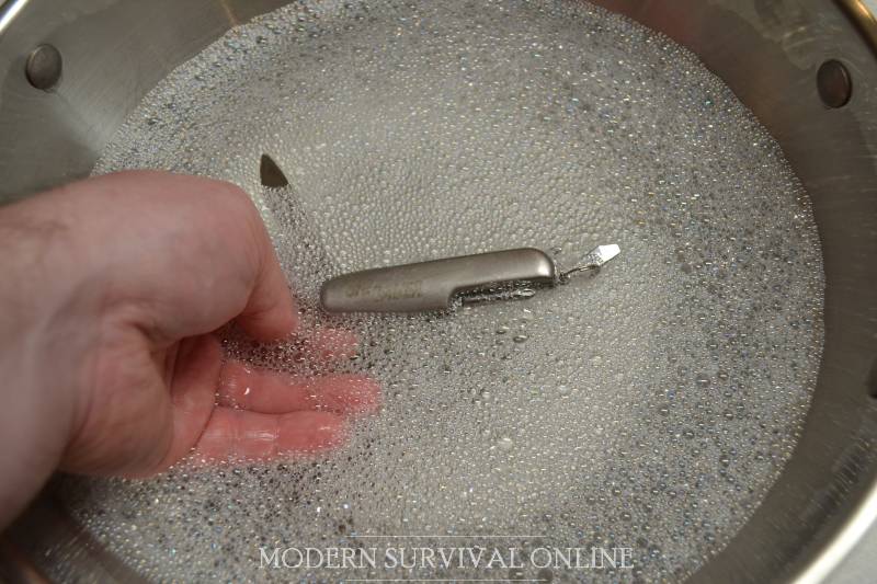 swiss army knife in hot soapy water