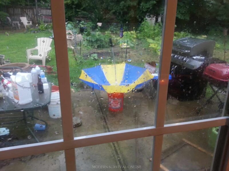 upside down umbrella in rain to collect rainwater