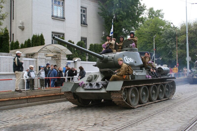 tank with soldiers on city street