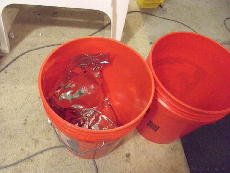two 5-gallon red buckets with sealed Mylar bags inside