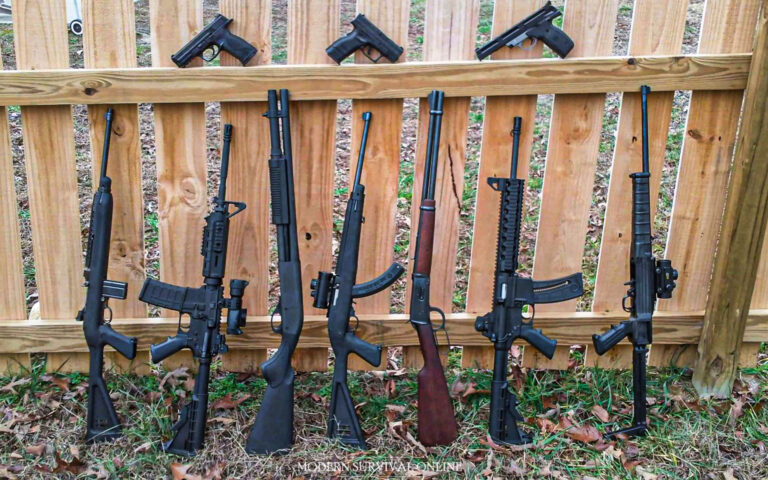 handguns and rifles near wooden wall