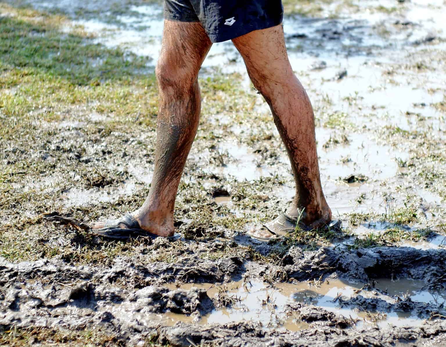 person walking in mud